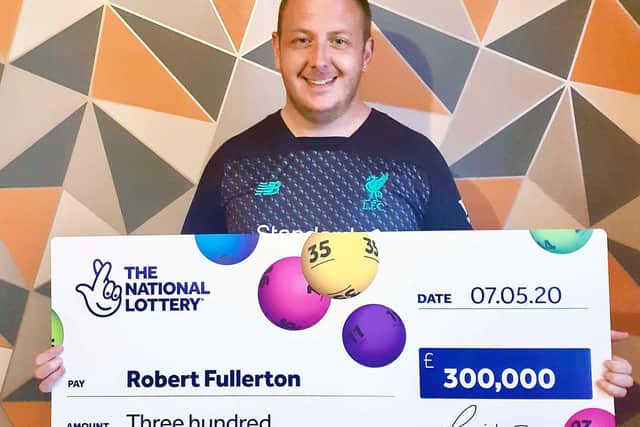 Robert Fullerton shows off the winning cheque.