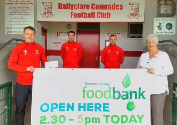 Meryl Carter from Newtownabbey Foodbank is pictured with Ballyclare players JB Dobbin, Kyle Crawford and Samuel McIlveen.