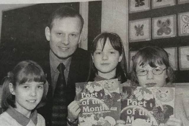 Carniny Primary School pupils Claire Murdock, Stephanie McCaig  and Rosalind Rowe whose poem's appeared in the local Library Board's 'Poet of the Month' magazine pictured with their principal, Mr Ross.