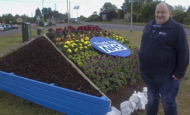 Cllr Gregg McKeen at the new floral tribute to NHS and keyworkers in Larne.
