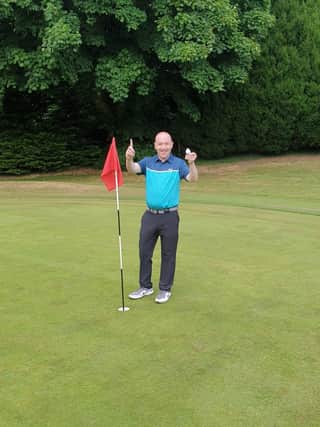 Gareth Robinson celebrates his hole-in-one success at Portadown Golf Club.