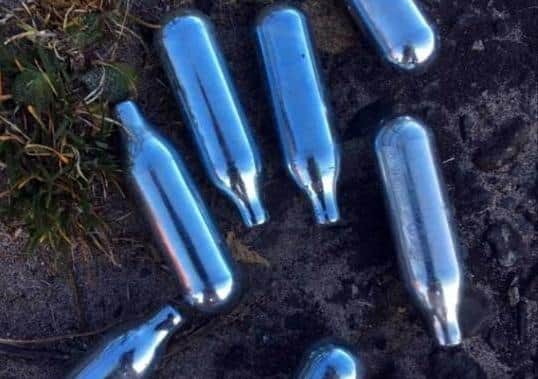 Silver canisters have been discarded on the beach, according to Cllr Donnelly.
