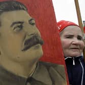 A woman carries a portrait of the Soviet dictator Josef Stalin during a traditional Communist Party demonstration in downtown Moscow on Tuesday, May 1, 2007. Picture: Dmitry Lovetsky/AP