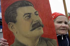 A woman carries a portrait of the Soviet dictator Josef Stalin during a traditional Communist Party demonstration in downtown Moscow on Tuesday, May 1, 2007. Picture: Dmitry Lovetsky/AP