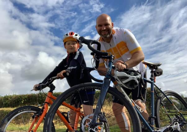 Cancer Fund for Children CEO Phil Alexander from Doagh and his son Caleb (8) are calling on people to get on their bikes this July to support children and young people impacted by cancer