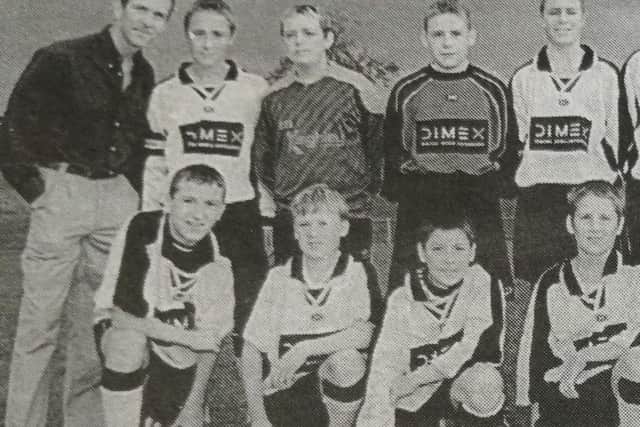 The St Nicolas Boys' Club Under 13 team with the managing director of DIMEX, George McKinney.
2000