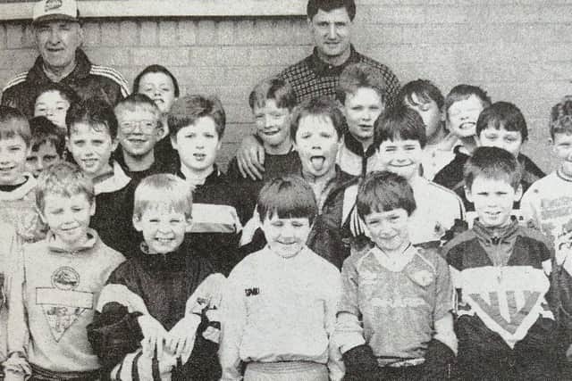 Pat McCourt and Jim Platt with some of the youngsters who took part in the Soccer School at Ballyclare Comrades Football Club.
1991