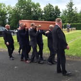 Mourners attending the burial of David Crocket at Burt Presbyterian Church in County Donegal today.