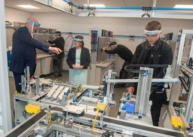 Economy Minister Diane Dodds with Principal and Chief Executive of Southern Regional College Brian Doran, and students