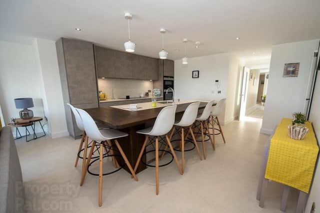 The property's features include a spacious open plan kitchen with living & dining areas