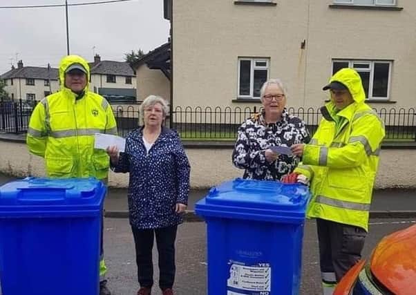 Cookstown North Community Group members Agnes McCracken (left) and Hazel McKenzie are pictured presenting vouchers to two Mid Ulster District Council refuse collectors.  A group spokesperson said they wanted to say  "a big thank you" from us for their continued work through this difficult time.  They added: "We purchased vouchers for Huchinsons butchers, Tesco and Finches Spar shop. We would also like to thank Alan Boyle at ATB Car Wash who gave us an extremely generous discount on a mini valet."