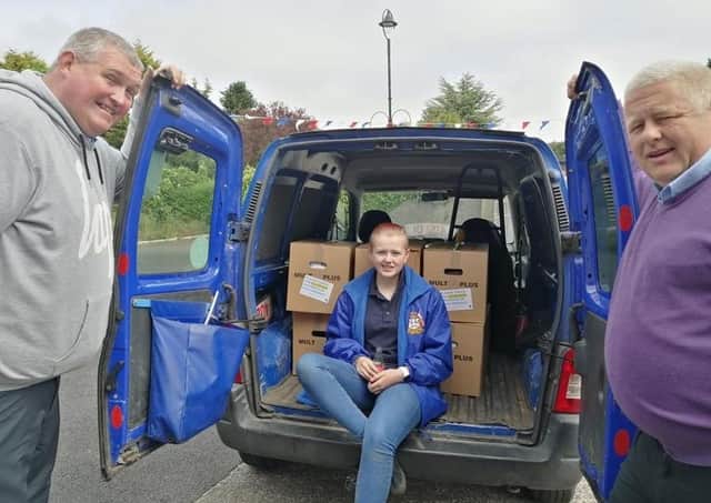Ian Patterson, Gemma Conn and Leslie Conn prepare to make a delivery