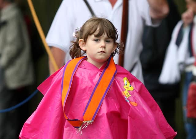 A young member of Galgorm LOL 329 dressed for a rainy day during the Twelfth parade in Ballymena. BT29-238AC