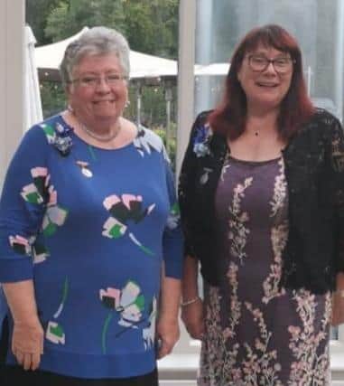 Katie McLean, president and Alison McAuley, chair, prepare to welcome guests to Greenisland Flower Arrangement Society's  45th anniversary dinner at Magheramorne Estate.