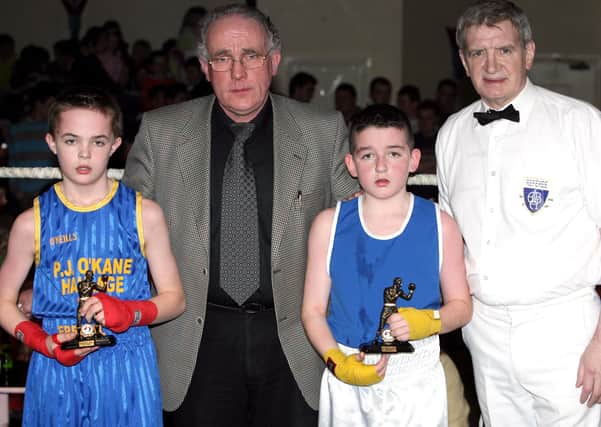 GREAT EFFORT...Tony McGahon and referee Eugene Duffy with Pierce McNicholl and Dylan Wilkinson after the 36kgs fight during Errigal ABC fight night in the Imperial Hotel Garvagh last Friday. CR7-195PL