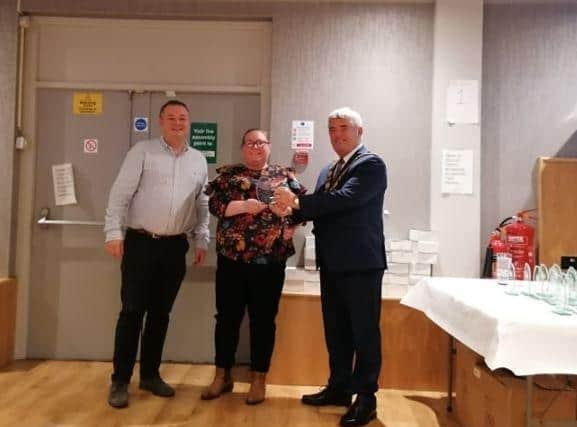 Mayor of Antrim and Newtownabbey, Cllr Billy Webb, presenting Emma Purdy with her Covid volunteer award, alongside Cllr Robert Foster.