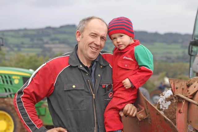Killead Ploughing Society vice-chairman William Johnston, and son Harry, enjoying the 104th match near Templepatrick. Picture: Julie Hazelton