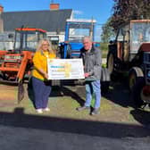 Ahoghill man Raymond Campbell pictured presenting Heather Miller, Fundraiser for Marie Curie with a cheque for £3325, proceeds from the vintage vehicle event that he organised in September.