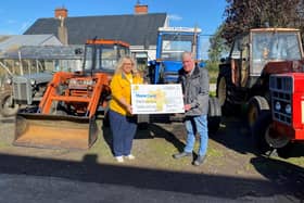Ahoghill man Raymond Campbell pictured presenting Heather Miller, Fundraiser for Marie Curie with a cheque for £3325, proceeds from the vintage vehicle event that he organised in September.