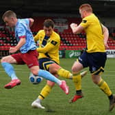 Newry City centre-back John Boyle clears his lines as Institute's Brendan McLaughlin challenges. Picture by George Sweeney