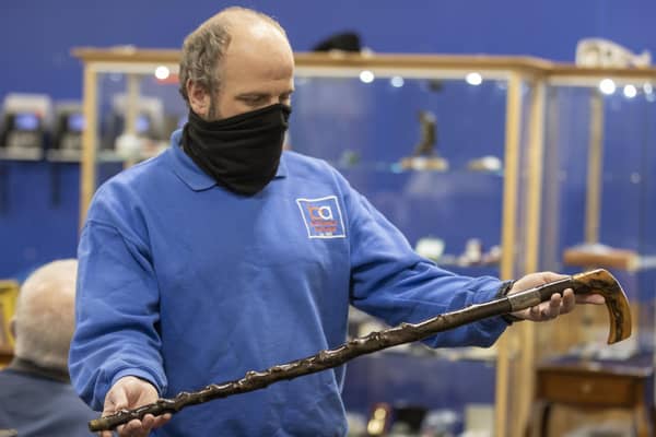 A member of the Bloomfield Auctions team in east Belfast, holds a walking stick once owned by Northern Ireland's first Prime Minister, James Craig, 1st Viscount Craigavon, which sold for £10,000 to an online bidder. It was estimated that the blackthorn cane would sell for between £4,000 and £6,000.