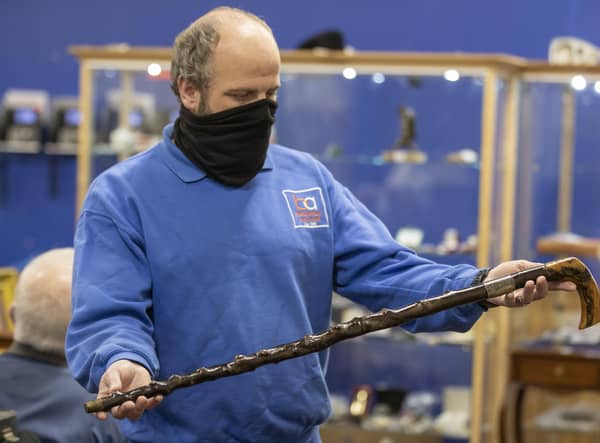 A member of the Bloomfield Auctions team in east Belfast, holds a walking stick once owned by Northern Ireland's first Prime Minister, James Craig, 1st Viscount Craigavon, which sold for £10,000 to an online bidder. It was estimated that the blackthorn cane would sell for between £4,000 and £6,000.
