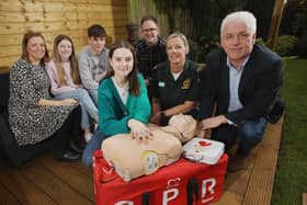 Back row L-R:  Mum Nicola King, Lucy’s sister Olivia, brother Thomas and dad Richard. Front row L-R: Lucy King who survived a cardiac arrest, Stephanie Leckey Community Resuscitation Lead with  NIAS, Fearghal McKinney Head of BHF NI