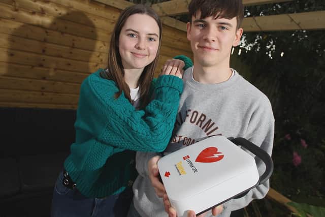 Lucy King who survived a cardiac arrest with her brother Thomas King who ran to retrieve the nearest defibrillator