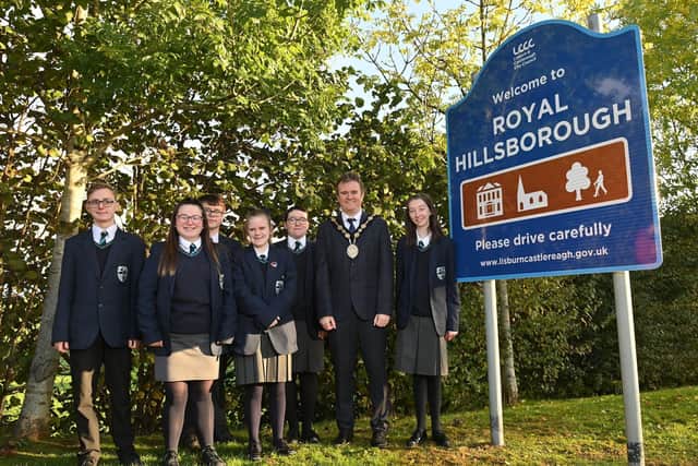 Mayor of Lisburn & Castlereagh City Council, Alderman Stephen Martin pictured with pupils from Beechlawn School at the unveiling of the new Royal Hillsborough signage.