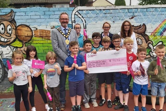 Larne Community Care Centre has been awarded almost £100,000 from the National Lottery's  Dormant Accounts Fund NI , included with staff and children is the Mayor of Mid and East Antrim, Councillor William McCaughey.