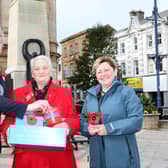 Poppy queen, Breeze Gilbraith receives a donation from Causeway Coast and Glens Borough Council Mayor, Richard Holmes and Councillor Sharon McKillop during the launch of the Poppy Appeal