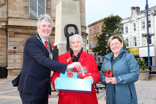 Poppy queen, Breeze Gilbraith receives a donation from Causeway Coast and Glens Borough Council Mayor, Richard Holmes and Councillor Sharon McKillop during the launch of the Poppy Appeal