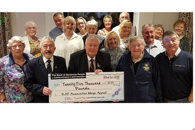 RAFA members and supporters proudly display another year's fundraising achievement with Joe Corr, Kevin McRandle MBE and Colin Murphy holding the cheque.