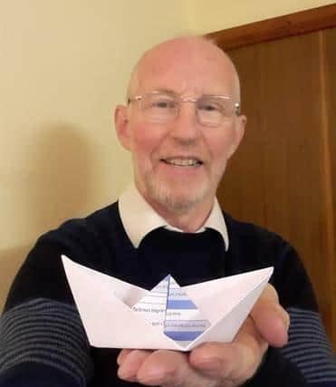 Colin Fisher made a folded paper boat inside which he wrote his hopes for the COP climate summit.