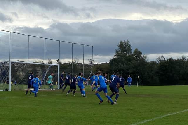 Carryduff Colts Seconds hat trick hero Jack Rafferty (number 9) ready to pounce supported by Danny Toal (number 4) against Civil Service