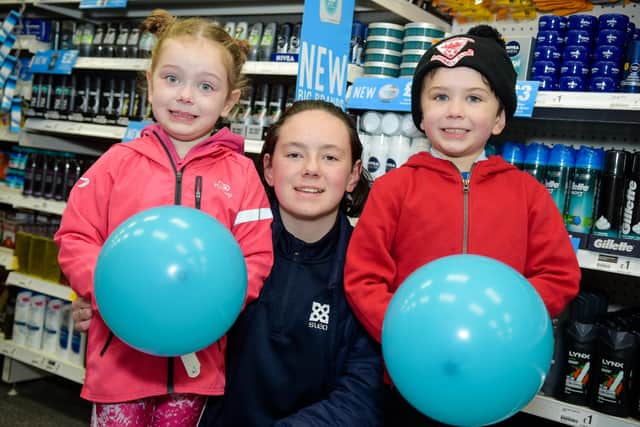 Imogen Taylor with her sister and brother Evelyn and Elijah at the new Larne Poundland.