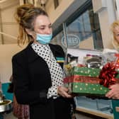 Wilma Bell, an original member of staff from first Poundland store opening in Larne, receives a gift.
