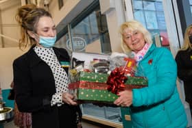 Wilma Bell, an original member of staff from first Poundland store opening in Larne, receives a gift.