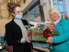 Wilma Bell, an original member of staff from first Poundland store opening in Larne, receives a gift.