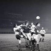 Lisburn Distillery's goalkeeper Terry Nicholson punches the ball away during a concentrated Linfield attack by Martin McGaughey and Peter Dornan, following a corner kick at Windsor Park in January 1982. Picture: News Letter archives