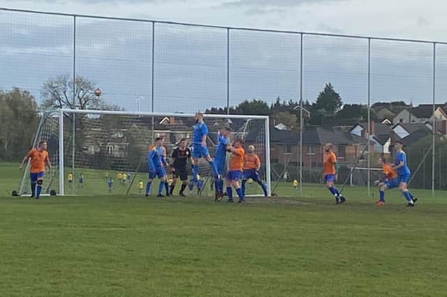 Conor O’Toole rises high for the Carryduff Colts seconds against Taughmonagh YM