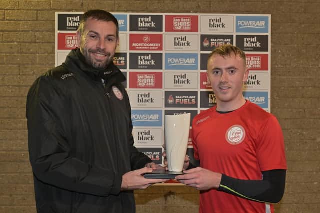 NIFWA Championship Player of the Month for October Richard Purcell receives his Belleek trophy from Ballyclare Comrades manager Paul Harbison.