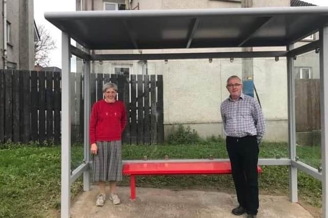Milltown resident Sheila Robinson at the new bus shelter with SDLP Cllr Eamon McNeill.