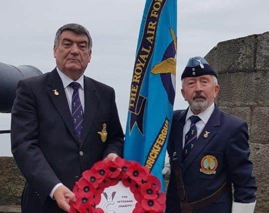 Wg Cdr Noel Williams, RAFA Carrickfergus Branch chairman and Joe Corr with the Veterans Charity poppy wreath at Carrickfergus Castle.