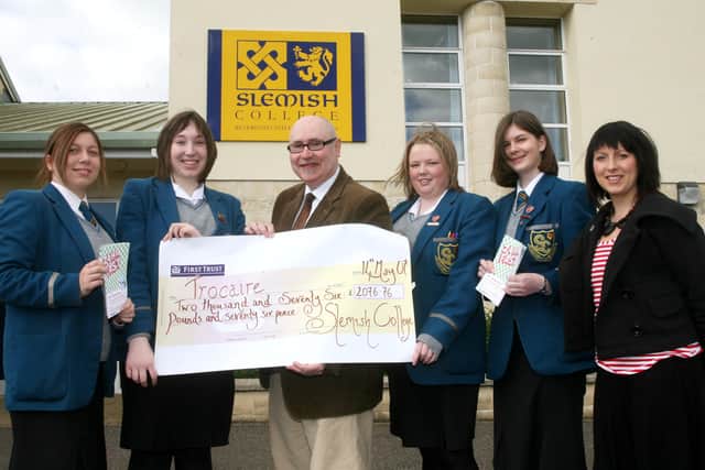 Paul Kane, of Trocaire, receives a cheque for £2076.76 from Slemish College students Nikki McClements, Serena Manson, Laura Millar and Amy Russell who took part in a sponsored 24 hour fast. Included is teacher Miss. C. Quail. BT20-211AC