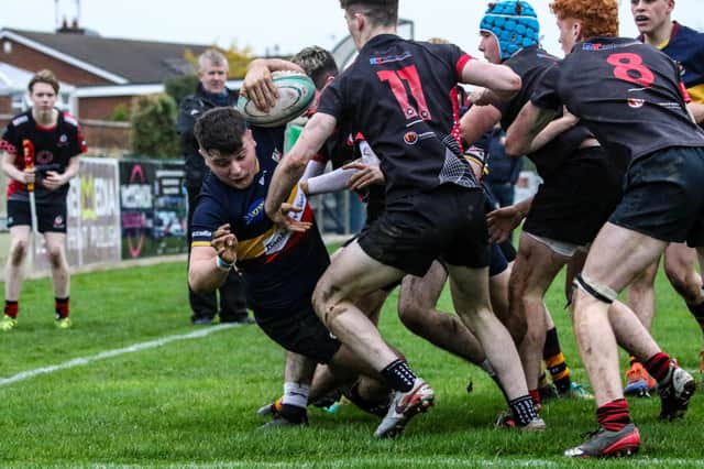 Kai Shields twists out of the Rainey U18 defence to claim his first try in a Bann shirt