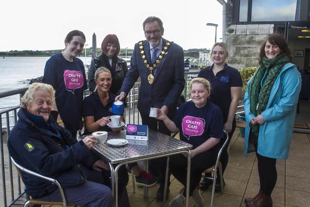 Staff members from the Prom Café alongside the Mayor, Cllr William McCaughey, Cllr Robert Logan, Yvonne Carson, Northern Health Trust and Deborah Neill, Mid & East Antrim Loneliness Network member. It is one of three Chatty Cafes opened in the town to tackle loneliness