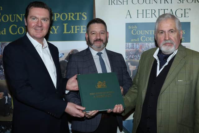 (From left) David Hinds, director of printers WG Baird Ltd in Mallusk and Don Hawthorne, project manager with the company,  present the first copy of launch ‘Irish Country Sports: A Heritage’ ‘hot off the presses’ to editor Albert Titterington.