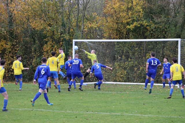 Fergus McBride goes close for Carryduff Colts with a header against Newhill