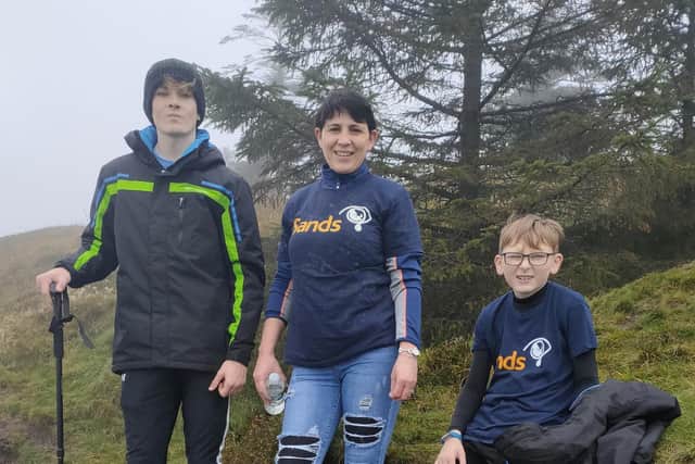 Angela Whyte pictured with her sons Joshua and Jay as they completed a hike over Slieve Gallion in the Sperrins as part of their 310,000 steps for SANDs.